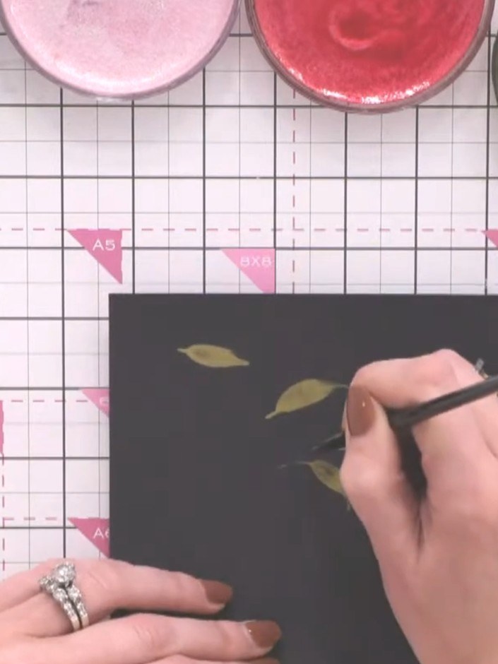 Step 5: Continue painting leaves using the toe-belly-toe motion with the olive green paint. Create multiple leaves in 