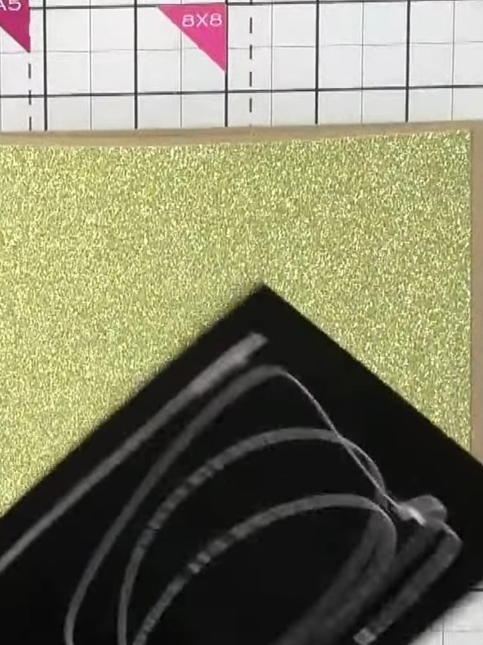 Step 3: Heat emboss the stamped image with gold embossing powder. The gold glitter frame now has a black heat-embossed