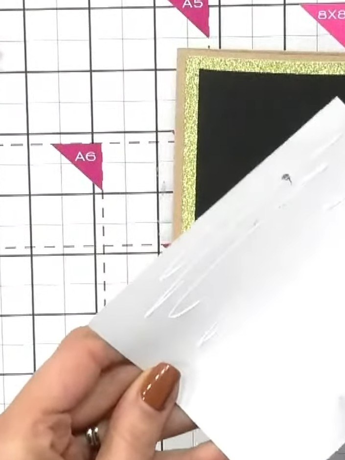 Step 5: Select a coordinating sentiment from the die set, such as 'thank you', and position it on your white card pane