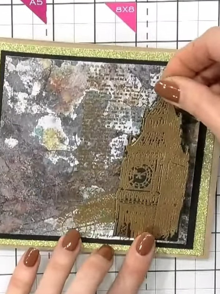 Step 6: Position the gold stamped sentiment piece onto the card front, placing it in the lower right area to balance t