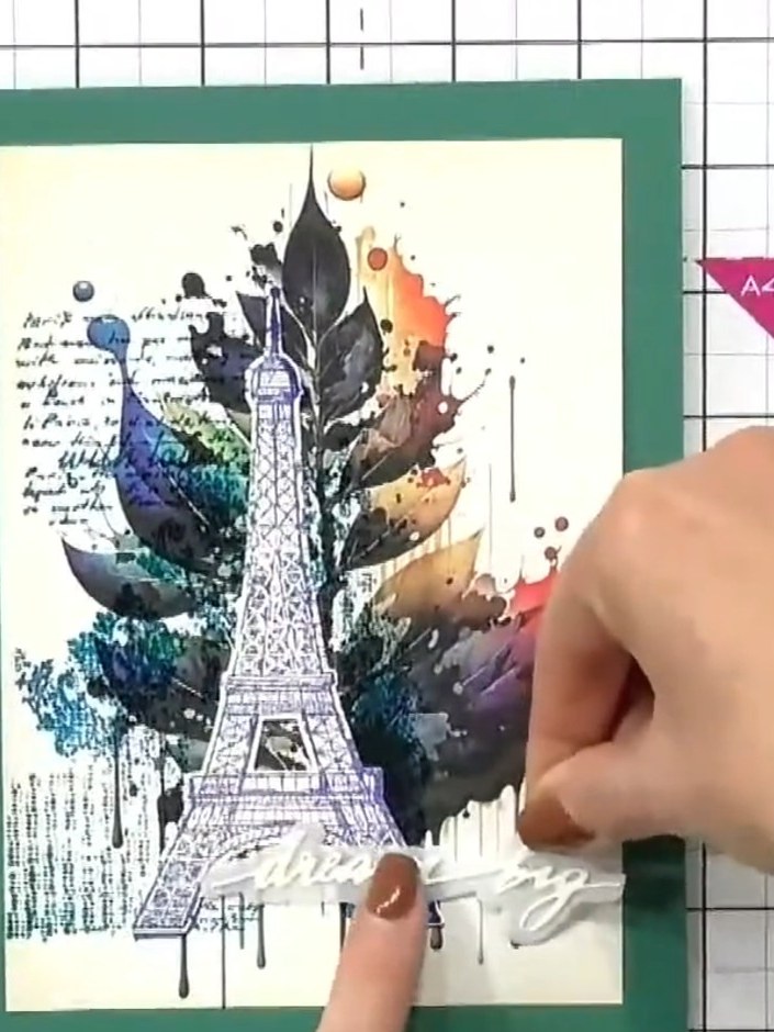 Step 7: Klebe einen gestanzten Spruch „dream big“ unten rechts auf die Karte.