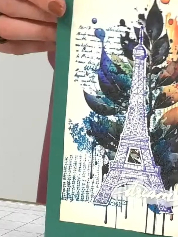 Step 8: Mount the finished Eiffel Tower design onto a teal card blank. The colourful watercolour feather design with t