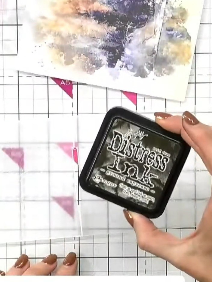 Step 1: Brush ground espresso or brown Distress Ink onto both sides of the embossing folder, covering the raised leaf 