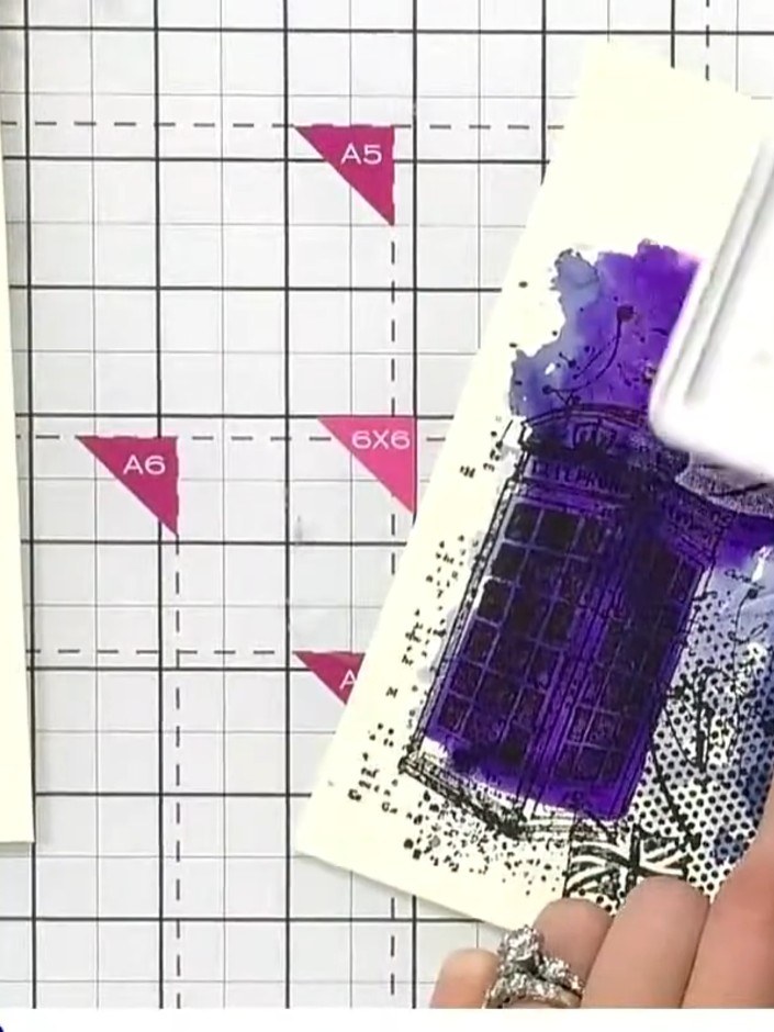 Step 11: Use white ink to highlight the embossed details on the purple stamped image, bringing out the texture and addi