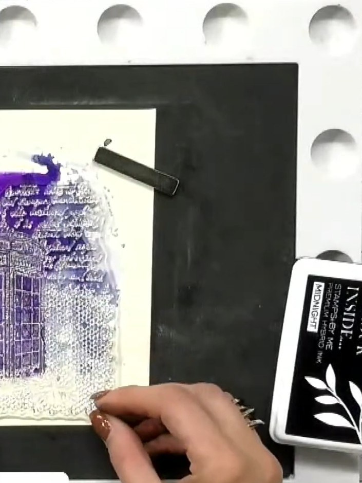 Step 6: Stamp the clock tower image onto your textured background using purple ink. Position the tower as your focal p