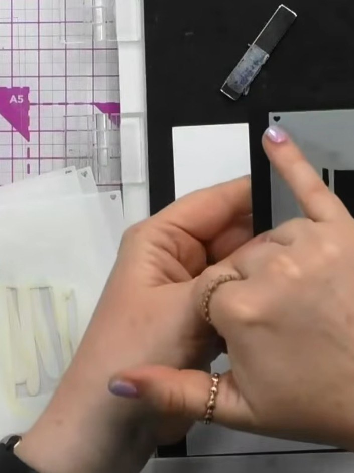 Step 1: Position stencil number one on your card base. Using a blending brush, ink through the stencil with a light ta