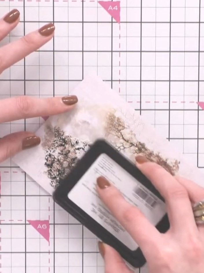 Step 3: Add touches of pink ink to scattered areas of the tree design using the ink applicator. Dab the pink ink light