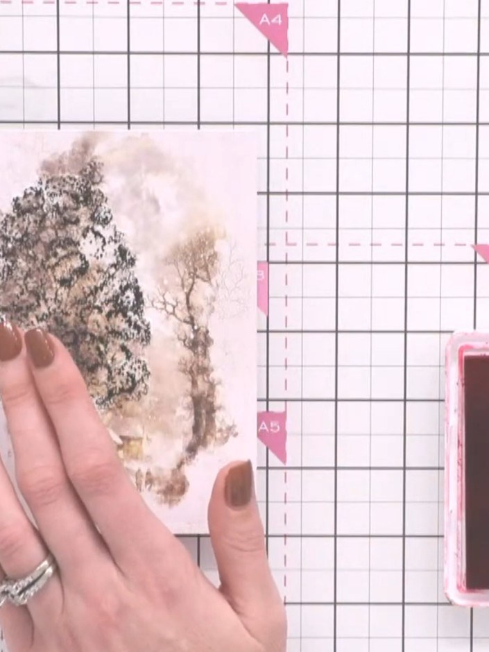 Step 5: Tap white pigment ink over the stamped tree design to soften the darker colours and create a snowy, dimensiona