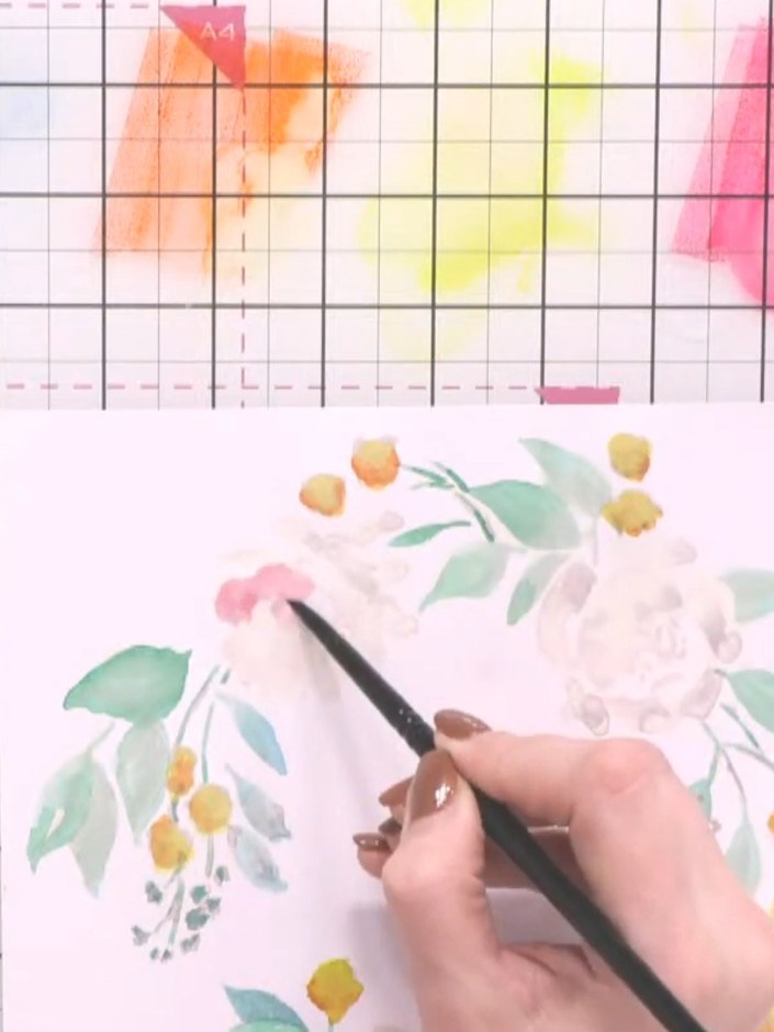 Step 6: Paint the main flowers in pink and orange, following the printed guide. Add darker tones to create depth and d