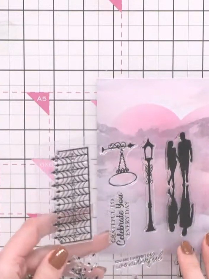 Step 5: Stamp the tree element from the stamp set in pink ink onto the watercolour background, positioning it to appea