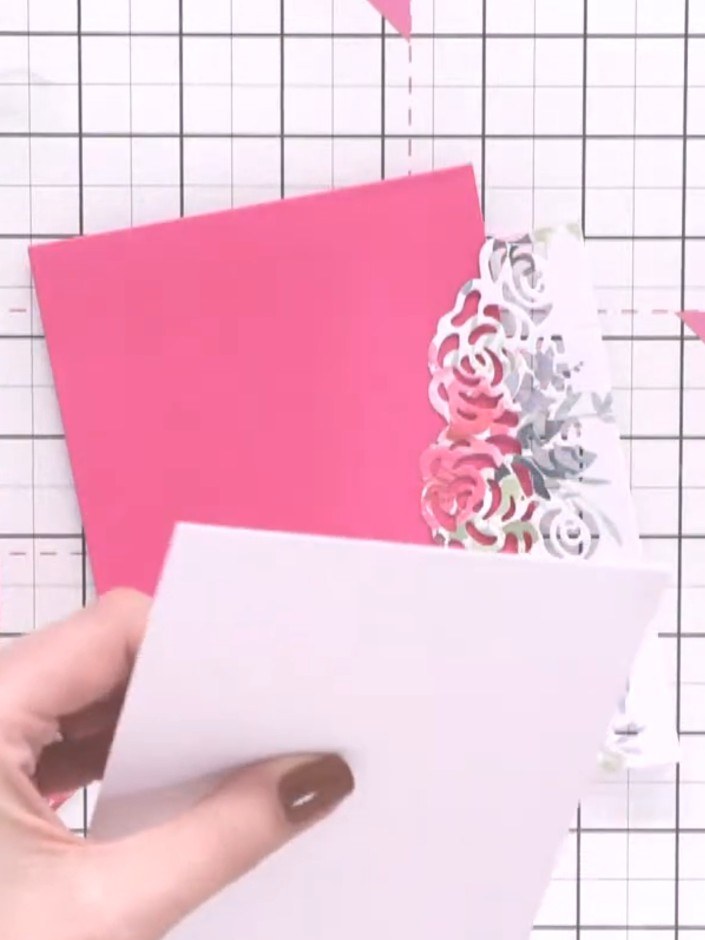 Step 8: Apply glue to the back of the white wrap and fold panel. Position it onto the pink A6 card base, ensuring it i