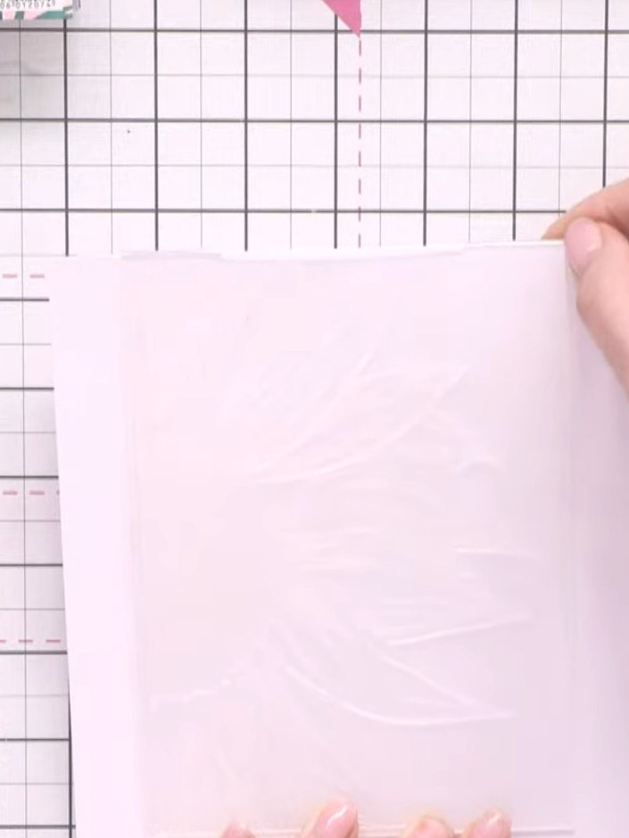 Step 1: Cut two pieces of white card stock. Position your 5x7 embossing folder flush to one edge of each piece, leavin
