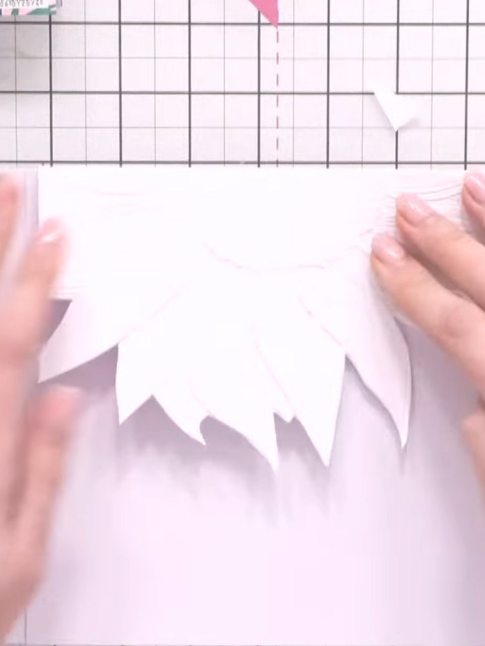 Step 7: Position the patterned paper onto the front of the white card blank, ensuring the embossed sunflower detail is