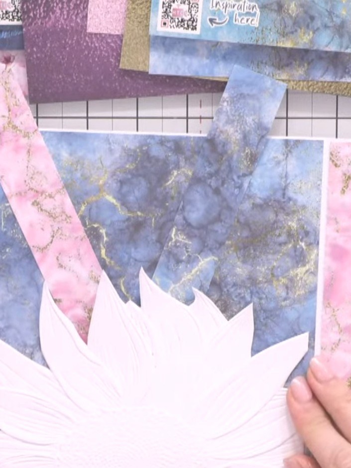 Step 8: Fussy cut decorative elements from your patterned paper, such as flowers or leaves. Layer these cut-out elemen