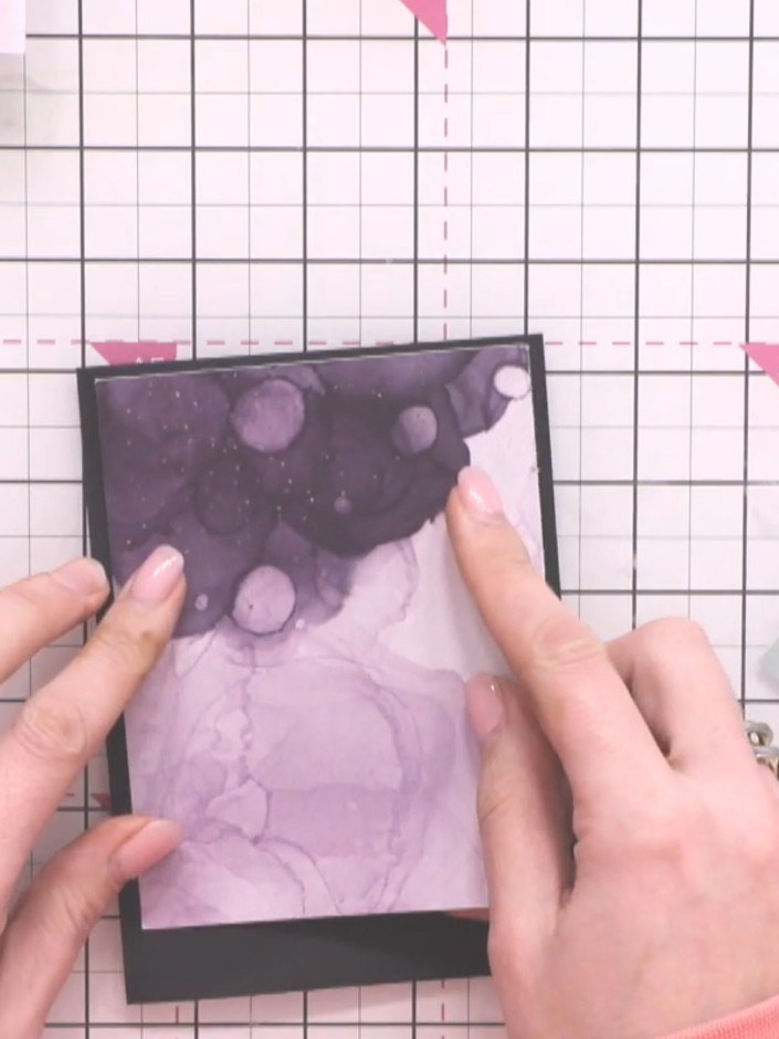 Step 2: Apply adhesive to the back of the pre-printed alcohol ink mount. Position and adhere it to the top of the blac