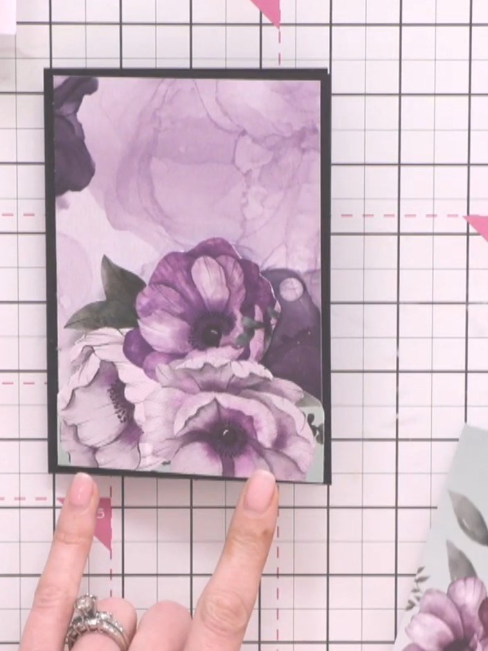 Step 7: Your mini card is now complete. The finished card features the purple floral panel mounted on the black frame 