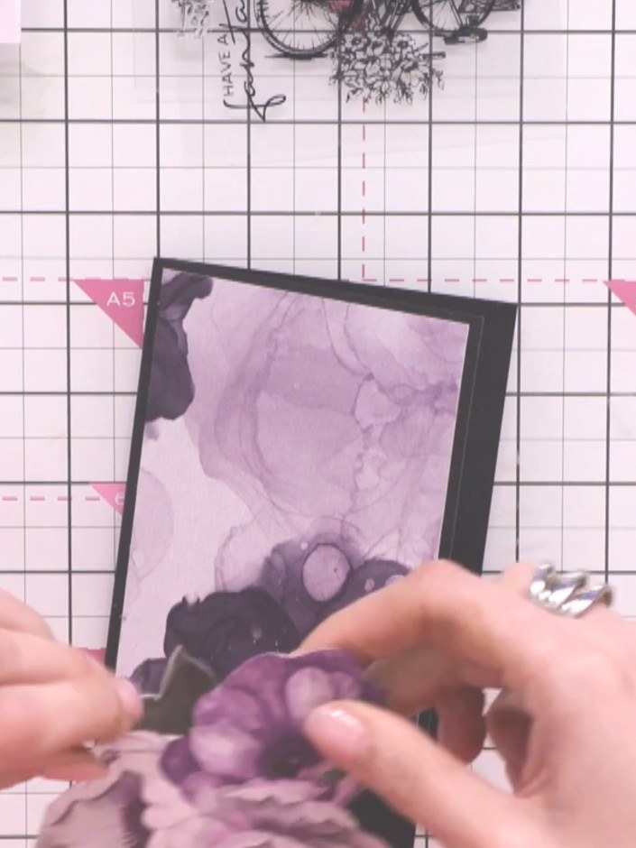 Step 6: Glue the die-cut bike to the bottom of your card base, securing it in place whilst allowing the flowers at the
