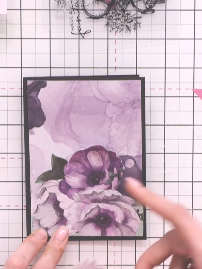 Step 7: Add fussy-cut flowers to the top of the bicycle stamp, positioning them to create a dimensional arrangement. U