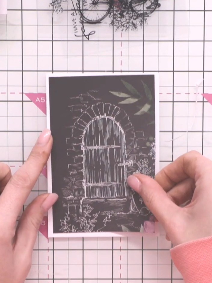 Step 1: Select a patterned paper from the Bloom & Grow paper pad featuring a decorative door design on dark background