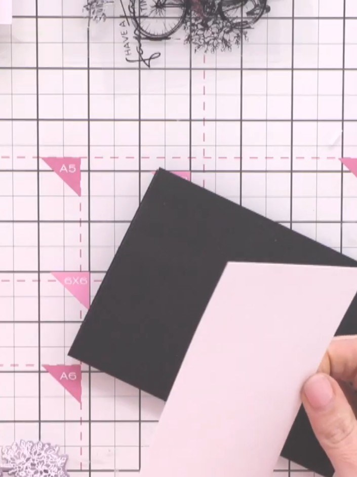 Step 9: Layer a white card stock panel onto the black card blank, positioning it centrally to create an even border ar