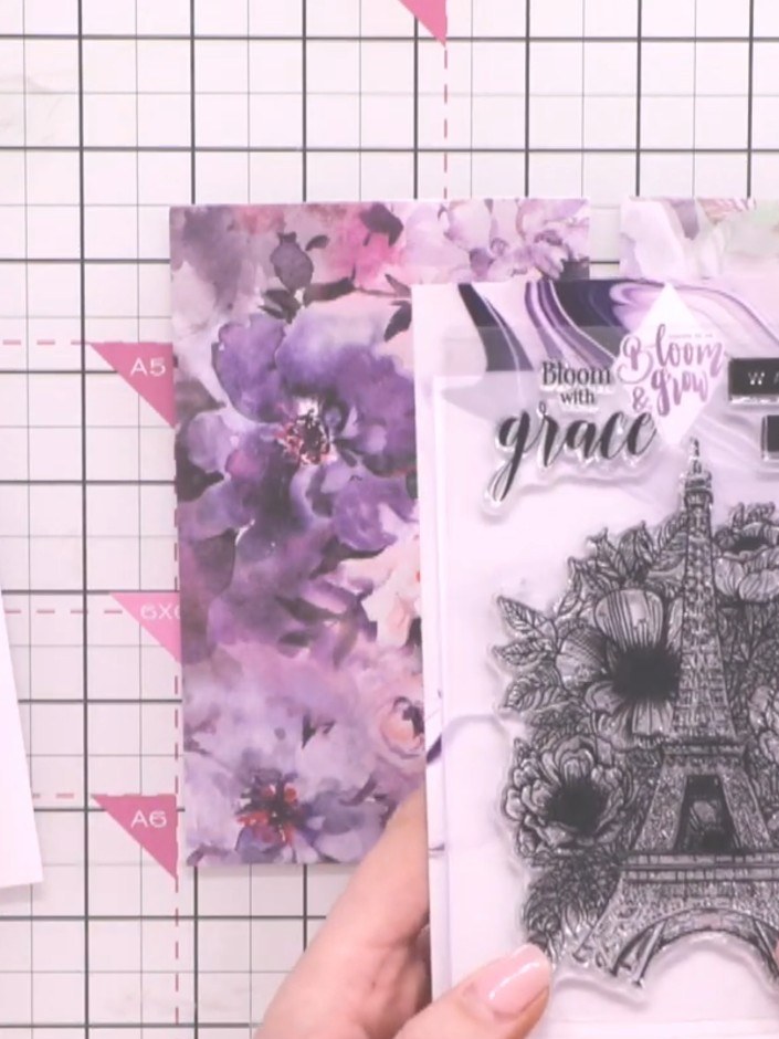 Step 1: Select your A6 clear stamp set featuring the Eiffel Tower design with floral elements. Prepare two pieces of p