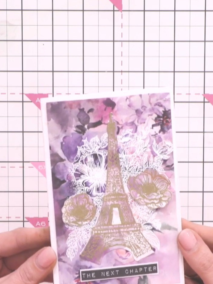 Step 12: Add the sentiment strip reading 'THE NEXT CHAPTER' flat to the bottom of the card front to complete your desig