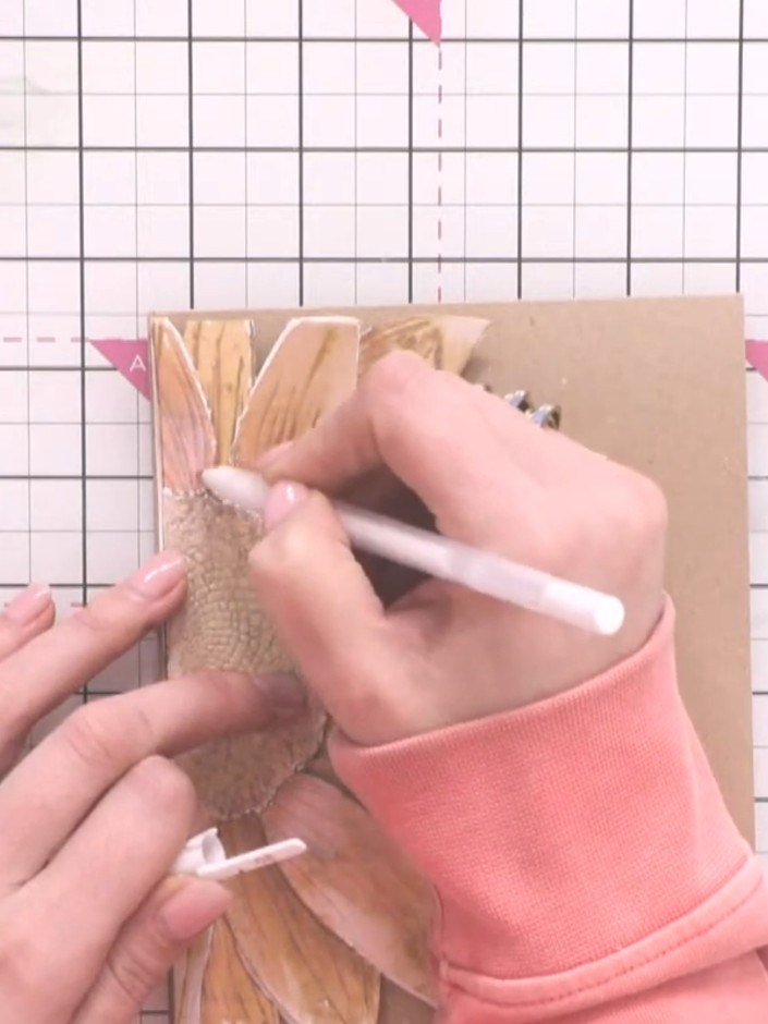 Step 14: Use a white gel pen to re-define any lost detail lines on the petals and bring back definition where embossing