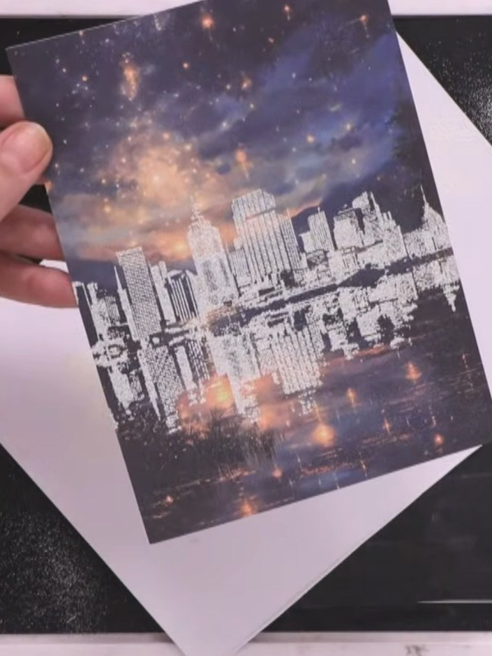 Step 7: Trim the stamped and embossed cityscape piece to size once the embossing powder has cooled completely. Use a t
