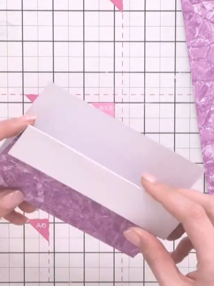 Step 3: Fold one edge of the white cardstock back approximately 1 inch (2.5 cm) to create a flap. Score the fold line 