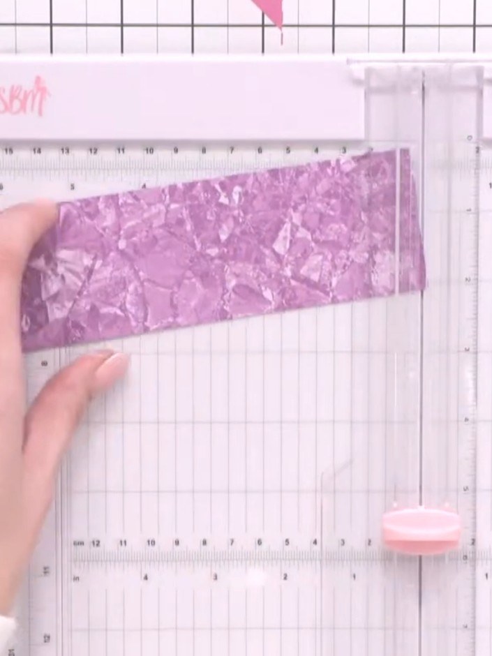 Step 4: Place the purple textured paper into the scoring board and position it to trim. Score and fold the paper to cr
