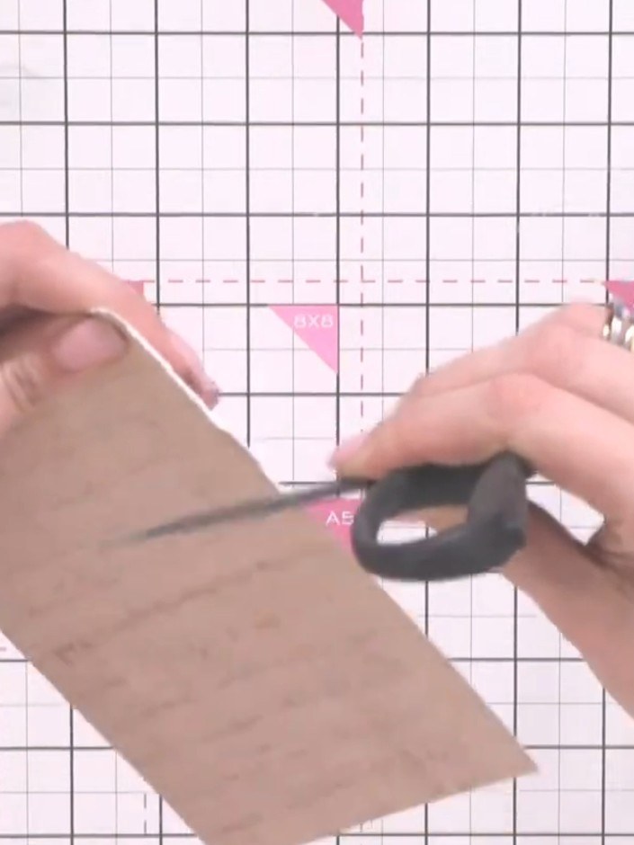 Step 1: Take a piece of cream or kraft cardstock and tear the edges using scissors to create texture and a vintage, ag