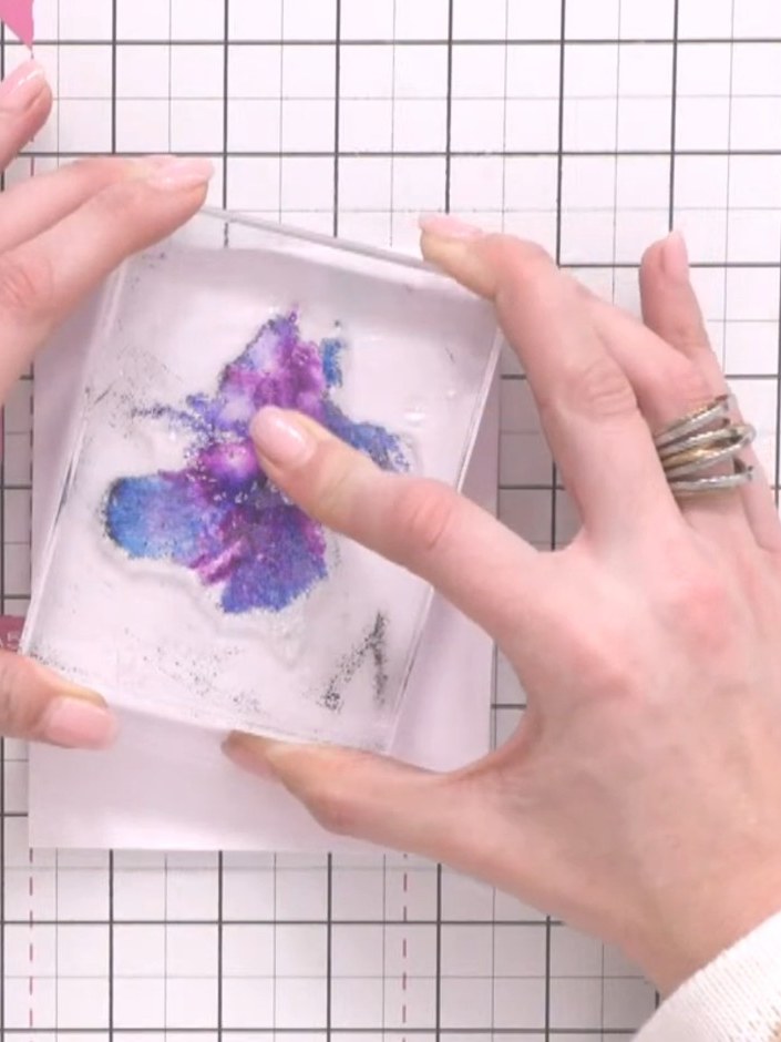 Step 5: Remove the stamp from the card and set it aside. Allow the watercolour design to dry completely using a heat g