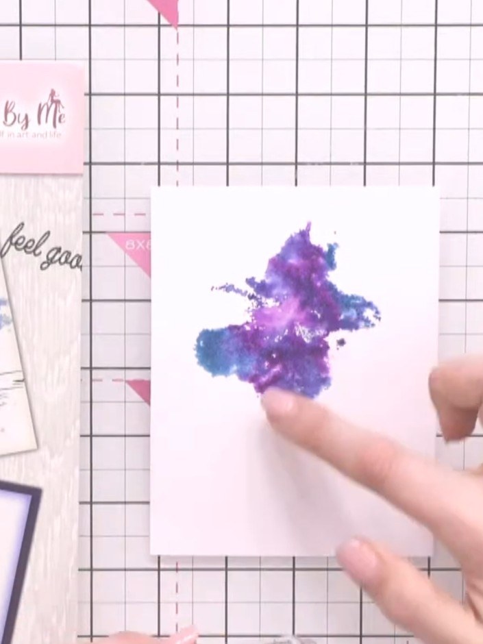 Step 8: Using a brush with water and ink, add splats around the watercolour background to create an artistic effect an