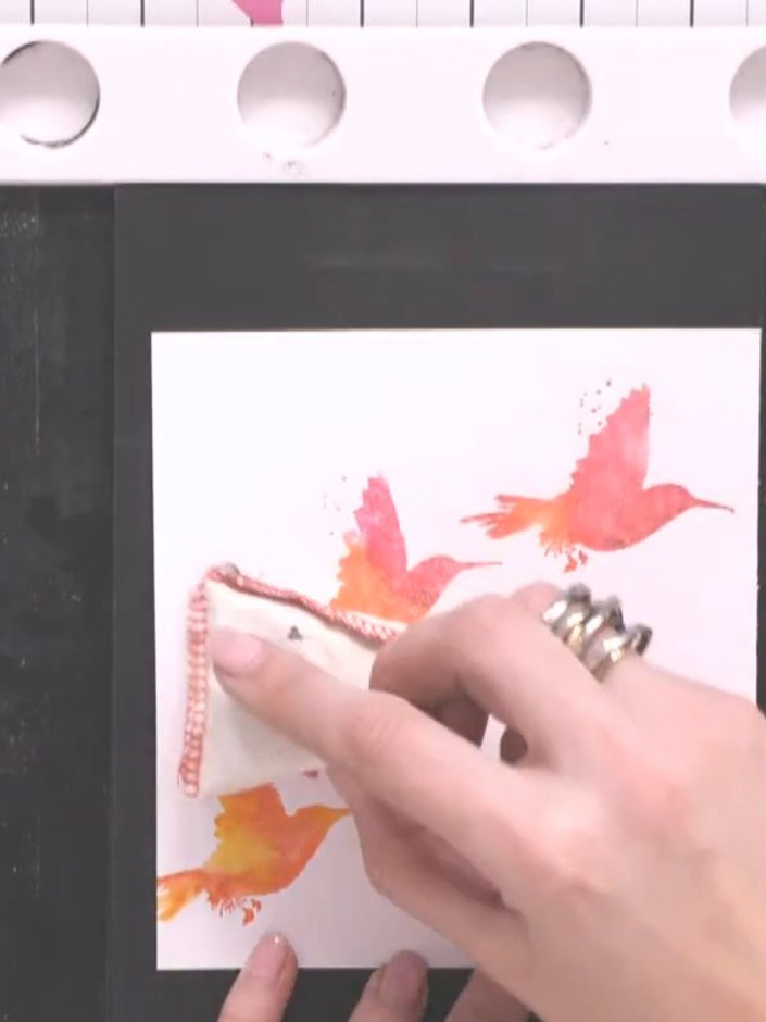 Step 10: Apply gold embossing powder over the wet embossing ink, ensuring all stamped bird areas are covered. Tap off a