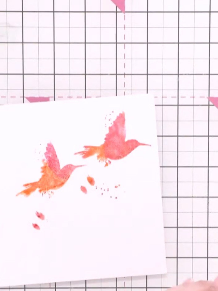 Step 4: Re-ink the stamp with fresh orange and pink ink, spray lightly with water, and stamp a second bird on the card