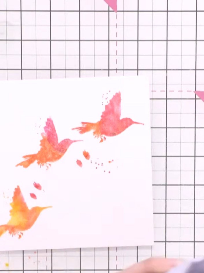 Step 6: Use a heat gun to completely dry the stamped birds on the card. Hold the heat gun over the card, moving it aro