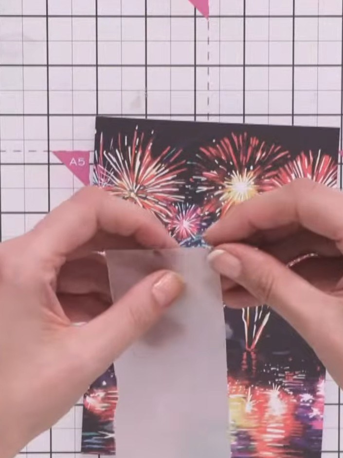 Step 1: Tear a piece of vellum by hand to create an organic, uneven edge. This will be placed over the fireworks image