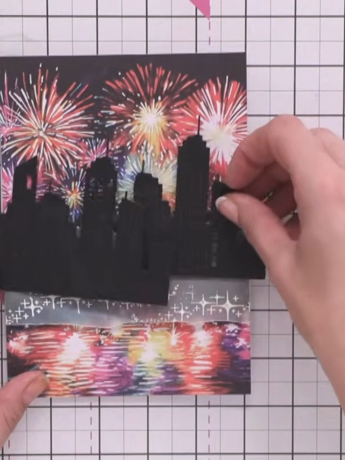 Step 8: Use your craft tool to pop out some of the die-cut window shapes from the black cityscape silhouette to create