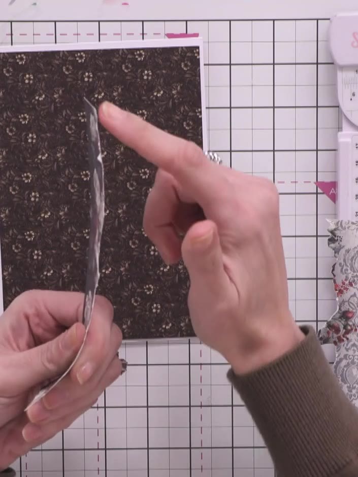 Step 10: Adhere the dark floral back panel to the reverse of the wallet, curling it slightly as you attach it to add di