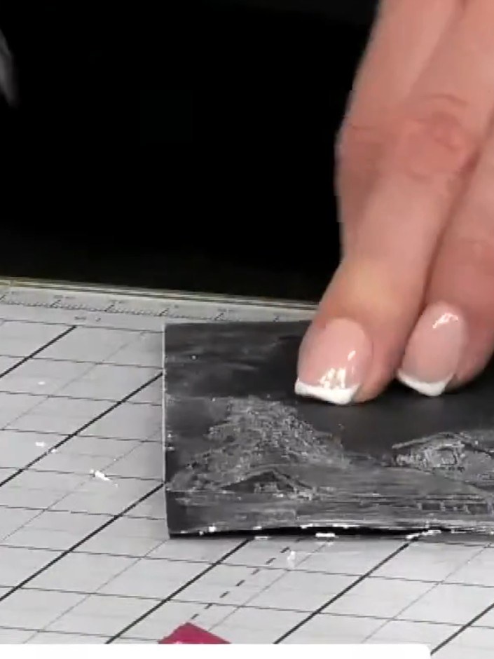 Step 7: Add colour to the edges of the black card using ink pads to frame the embossed design. Choose colours that com