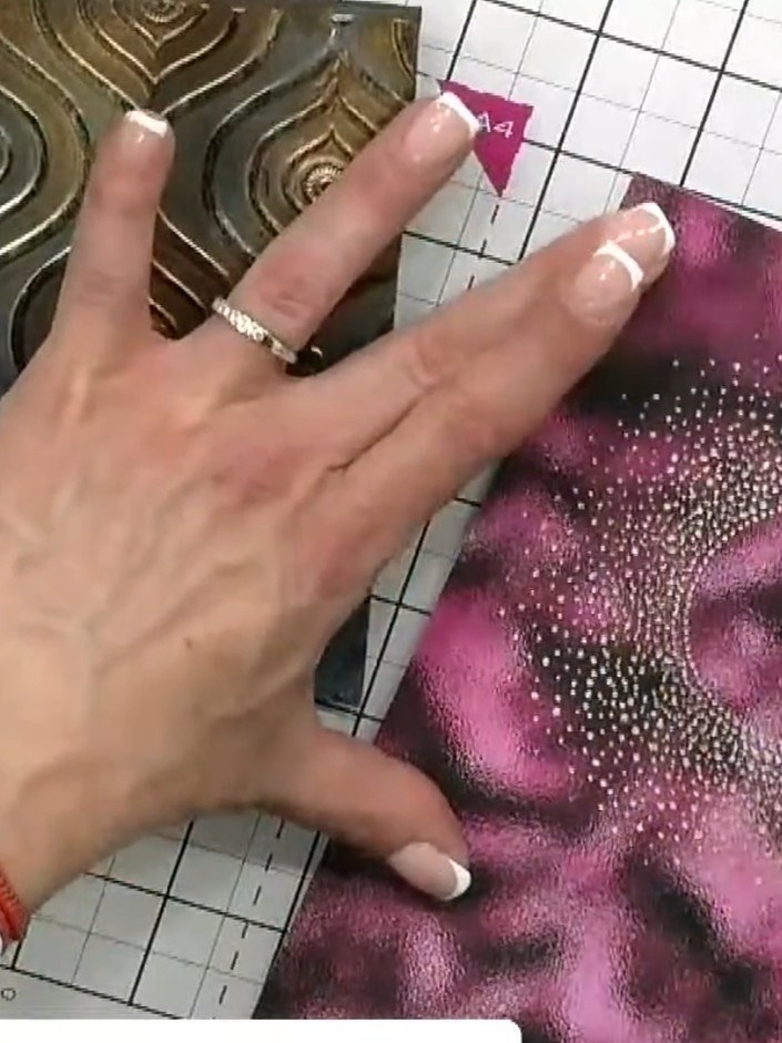 Step 2: Use a sanding block to gently sand back the raised embossed areas on the pink watercolour card, exposing the w