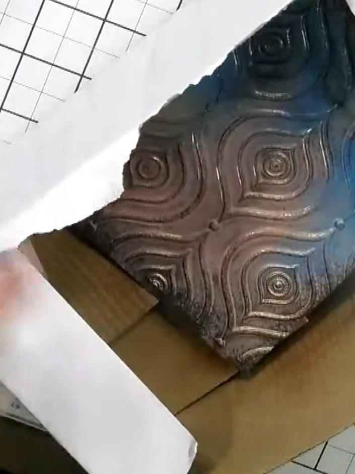 Step 3: Spray the embossed card with gold acrylic spray, ensuring the raised pattern areas are well covered with the m