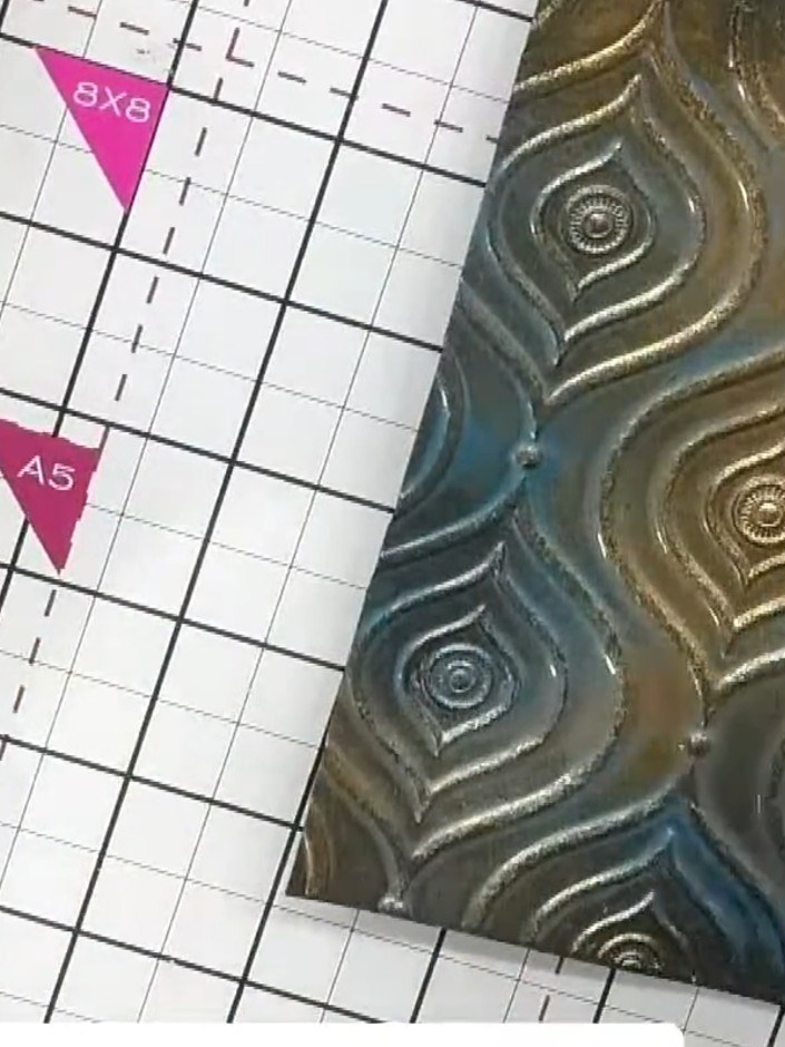 Step 5: Heat-set the sprayed card using a heat tool to dry the acrylic finish. Move the heat tool over the surface to 