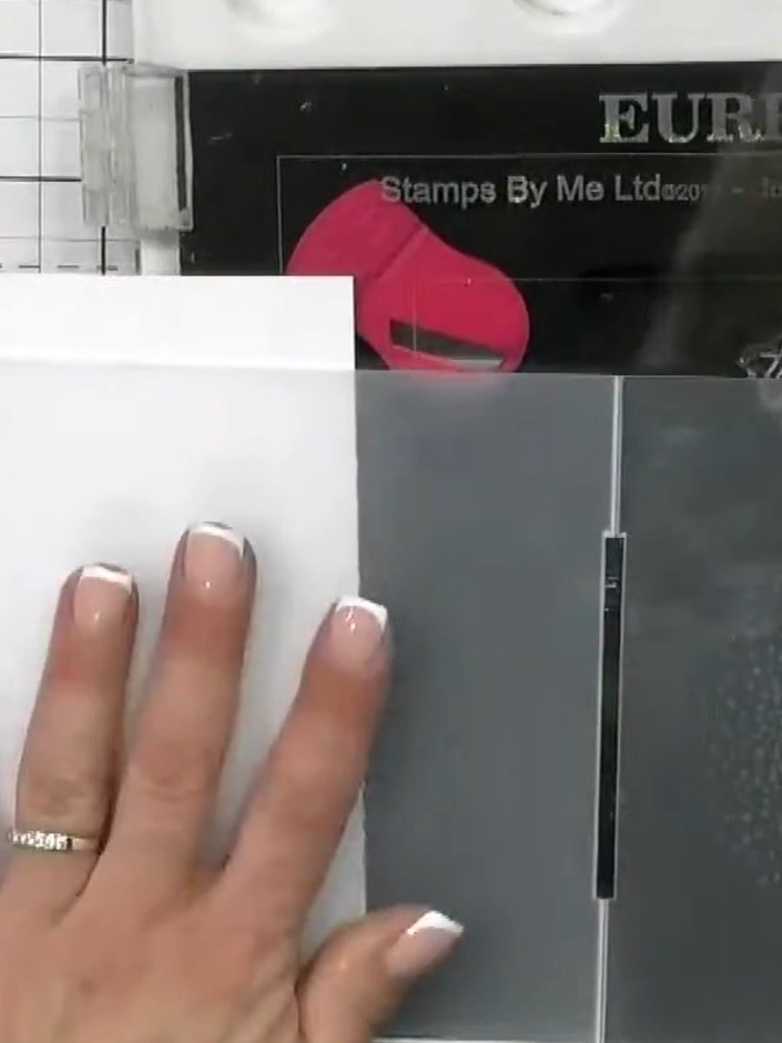 Step 1: Select your embossing folder from the Eureka 101 collection. Prepare your neon watercolour paints in pink and 
