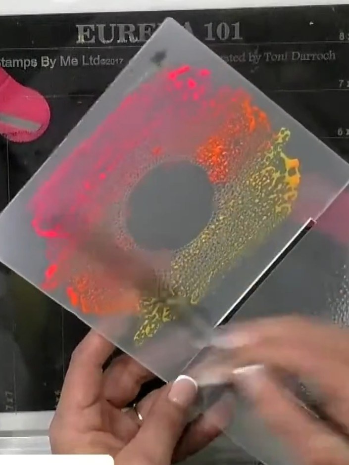 Step 6: View the finished sunset gradient effect on your embossed card. The neon pink, orange and yellow inks create a
