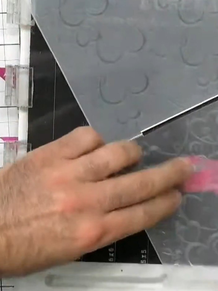 Step 1: Place your silver card stock into the embossing folder, ensuring the most raised part of the folder is positio