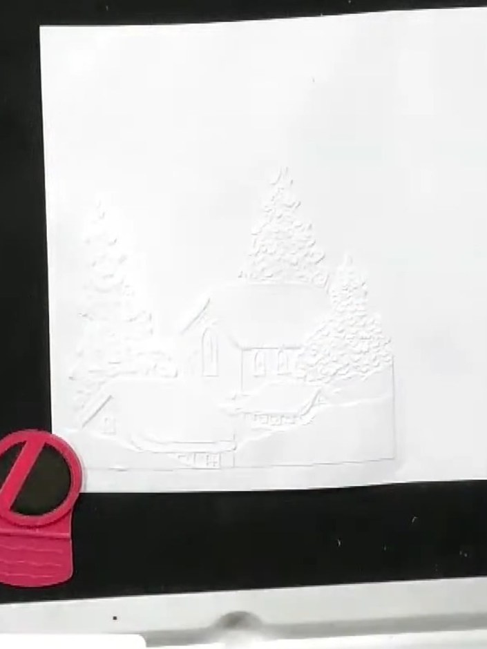 Step 1: Run your card stock through the embossing machine with the village scene embossing folder to create the textur