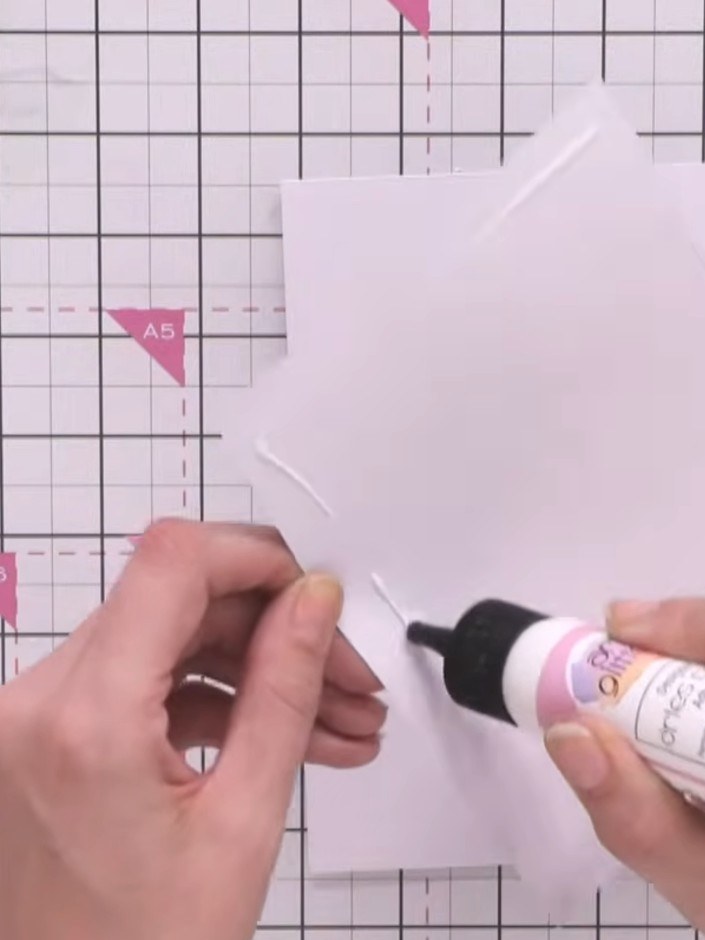 Step 8: Apply glue to the back of the trimmed vellum piece and mount it onto a white card blank, smoothing it down car