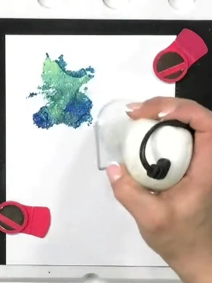 Step 3: Lightly spray the stamped background with water using a spray bottle. This will blend the ink colours together