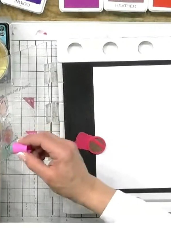 Step 5: Stamp the coloured tulip image onto your white card base in a single, firm motion. Press down evenly to transf